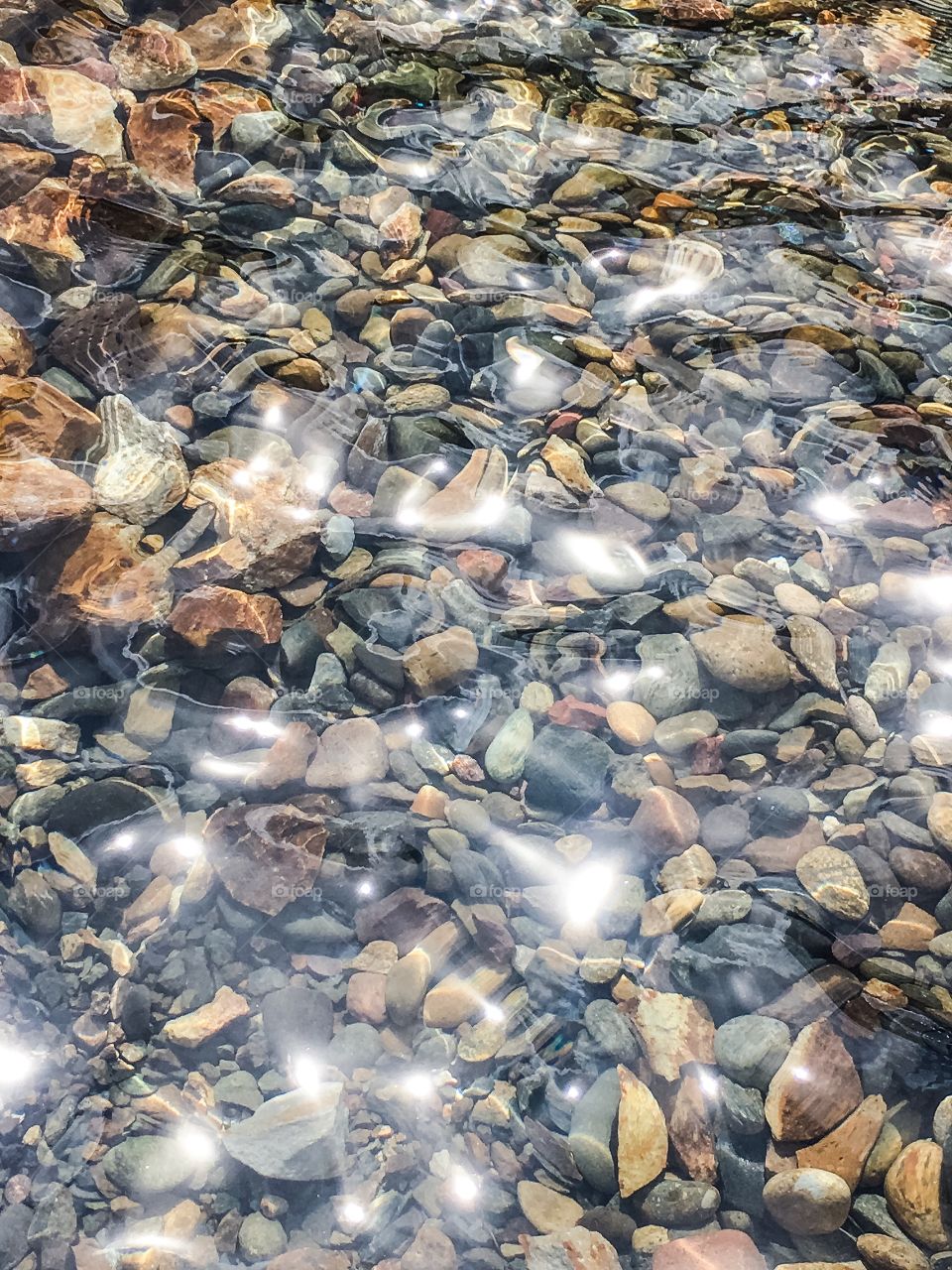 Sun reflecting off water and rocks 