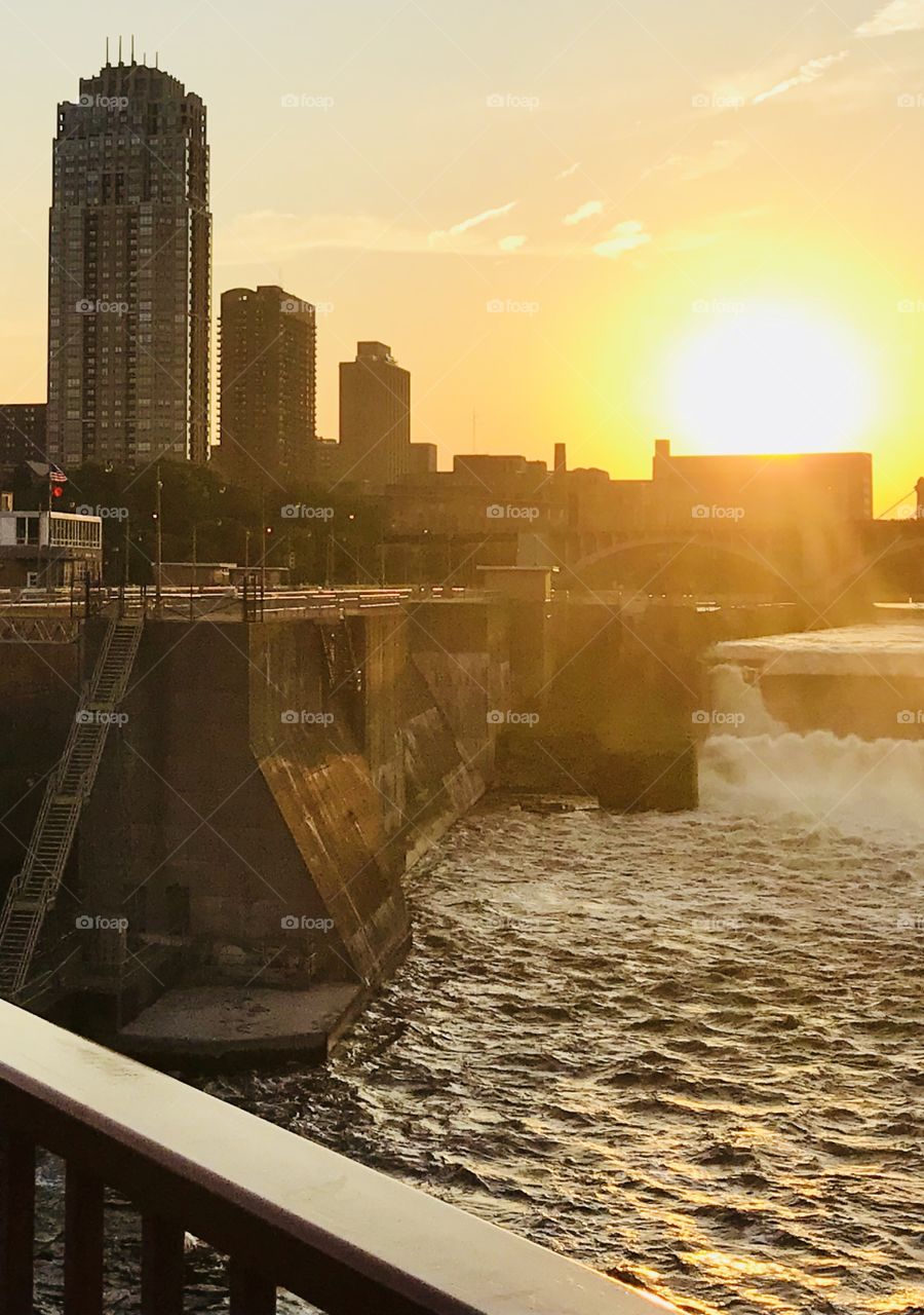 Stone Arch Bridge at Sundown Looking out over Beautiful Mississippi River Waterfall in Minneapolis Minnesota. 