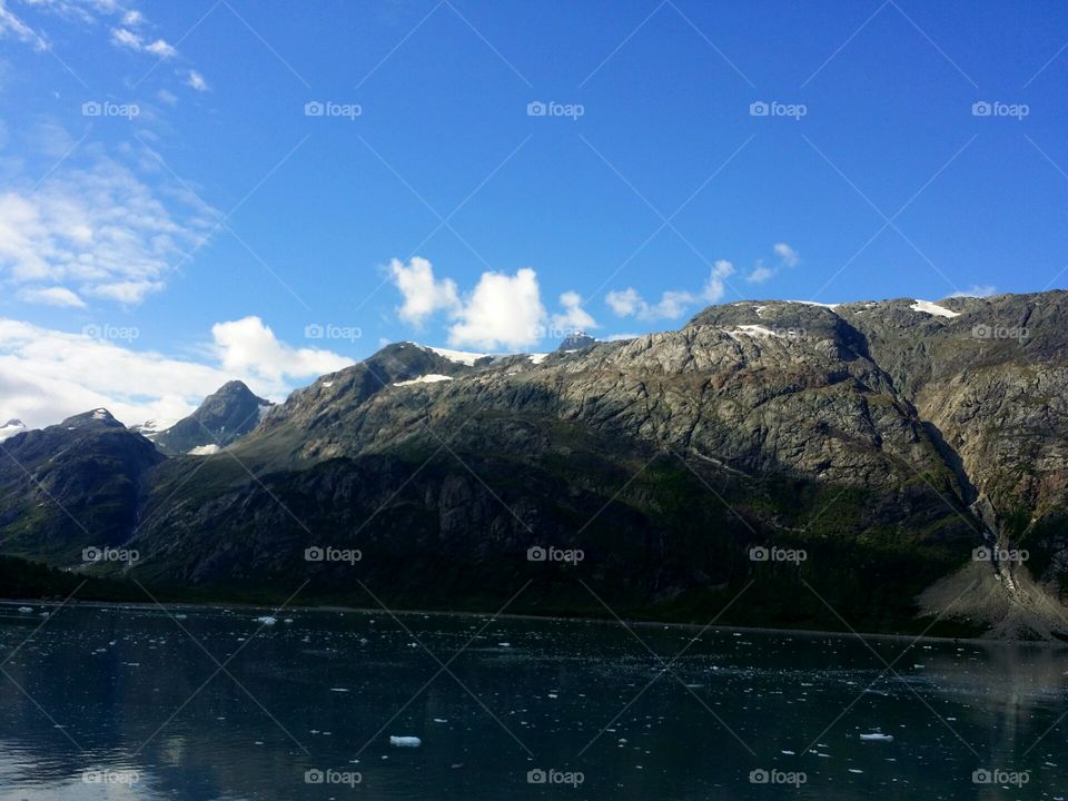 Glacier Bay National Park 
Rock mountains beautiful day with just a few clouds. 
Alaska