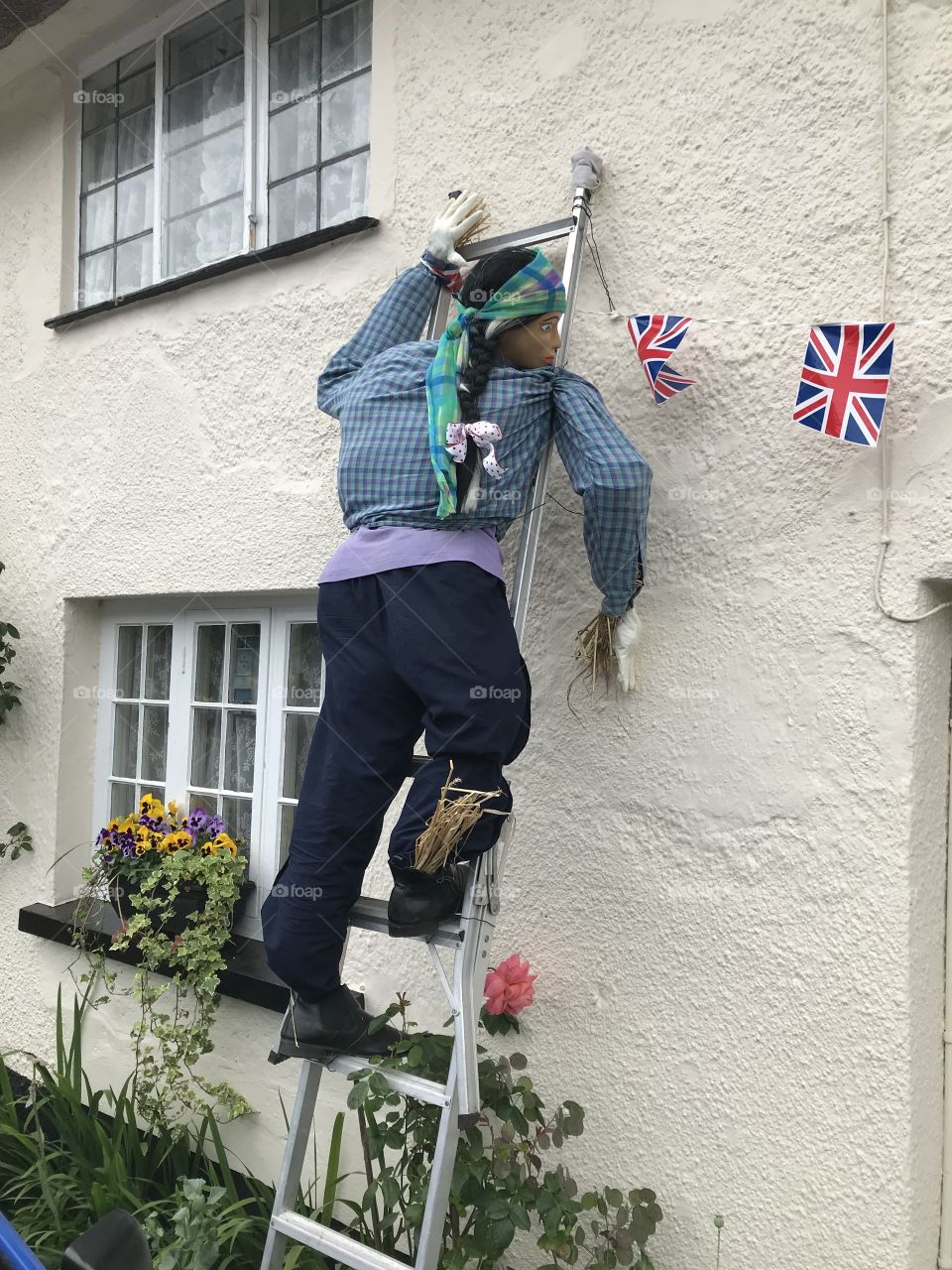 The second of two scarecrows who perhaps have time to clean some windows, to while away their time.