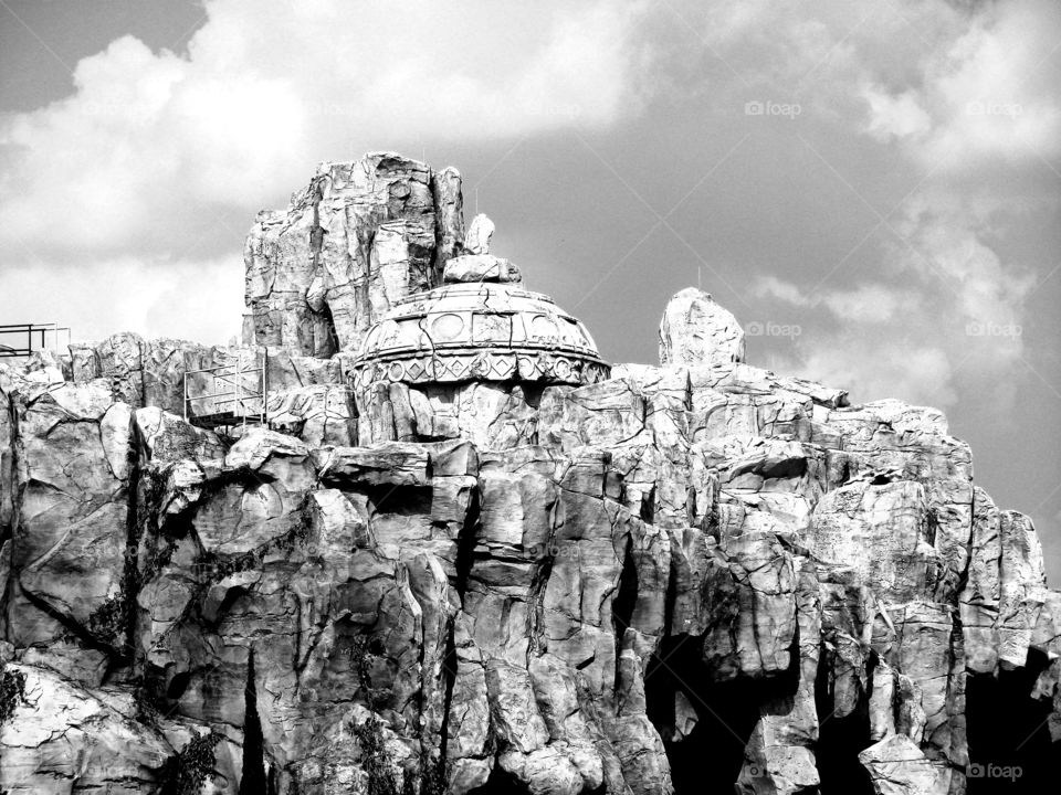An ancient item looms atop a rocky cliff. You never know what mysteries you'll uncover during your vacation to Universal Studios, Orlando Florida. Photo opportunities at every turn. New stories created ever minute. Memories to share.