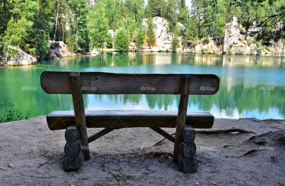 wooden bench at the lake in adrspach national park in Czech republic