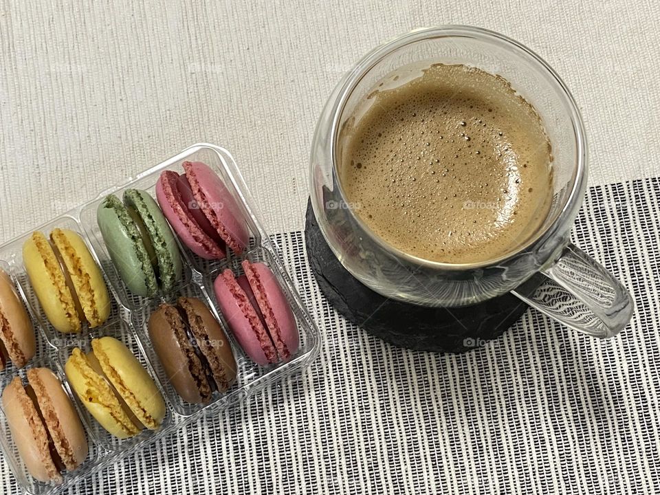 Colourful macarons and cup with coffee 