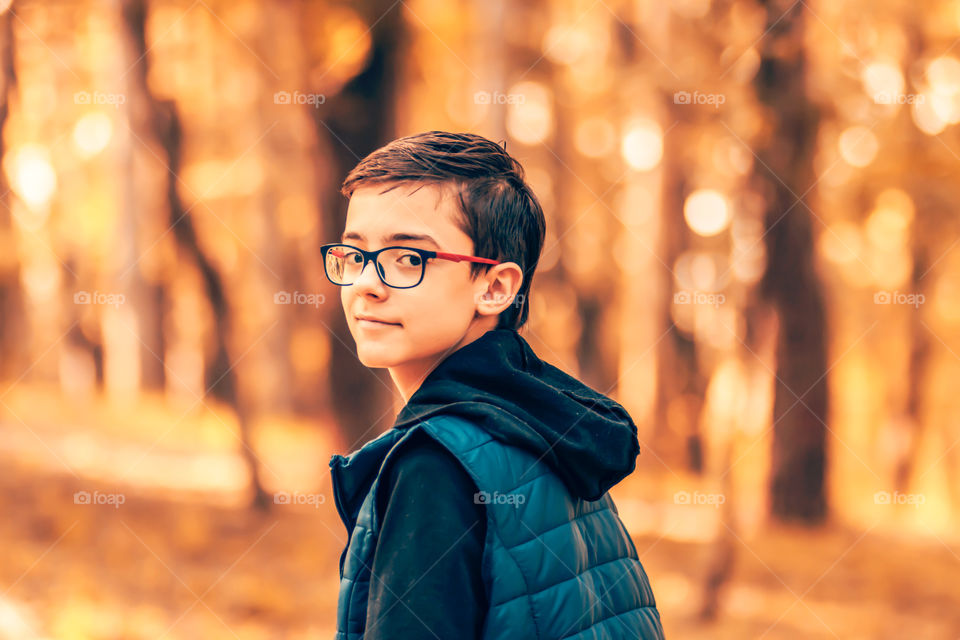 Portrait of teenager in casual close on autumn background.