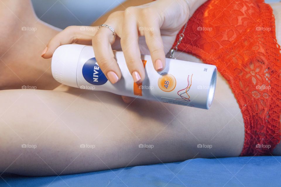 Woman using Nivea deodorant