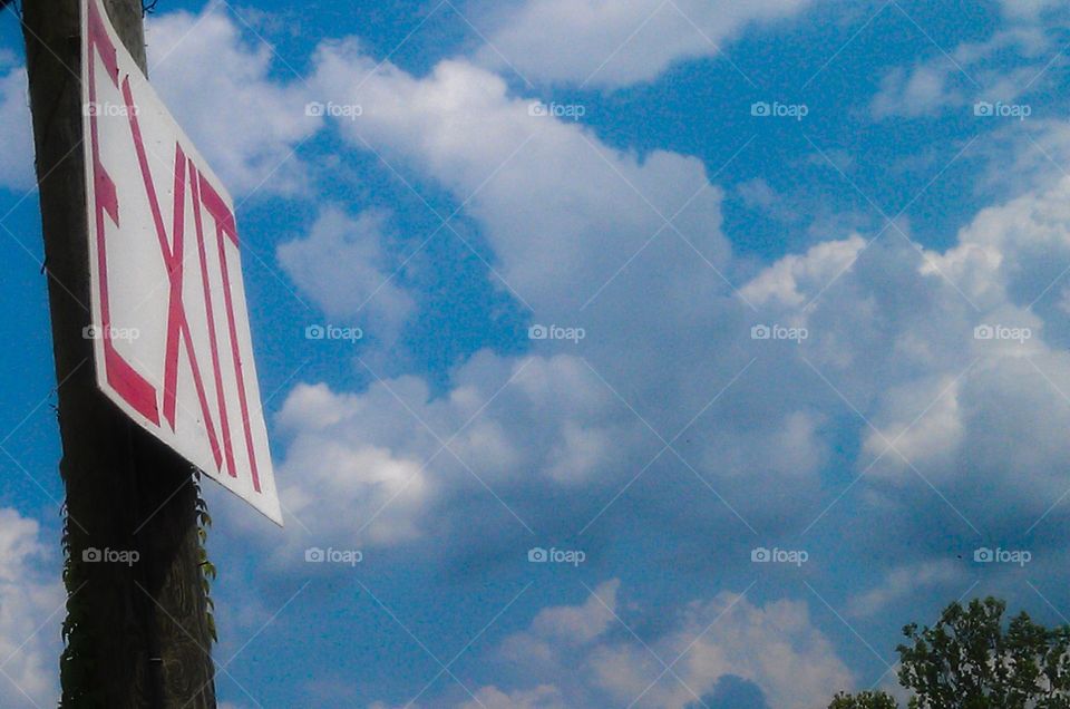 Exit. Exit sign against a heavenly sky 