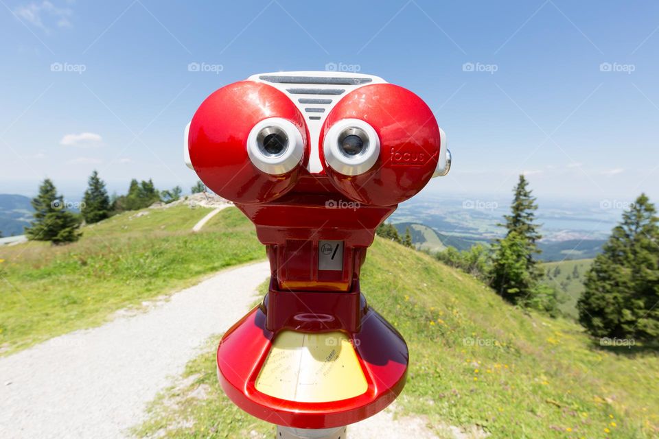 Funny looking tourist binoculars looking like a surprised face situated on the top of the mountain 