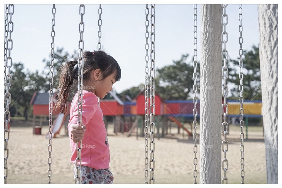 Asian kid on obstacle playground