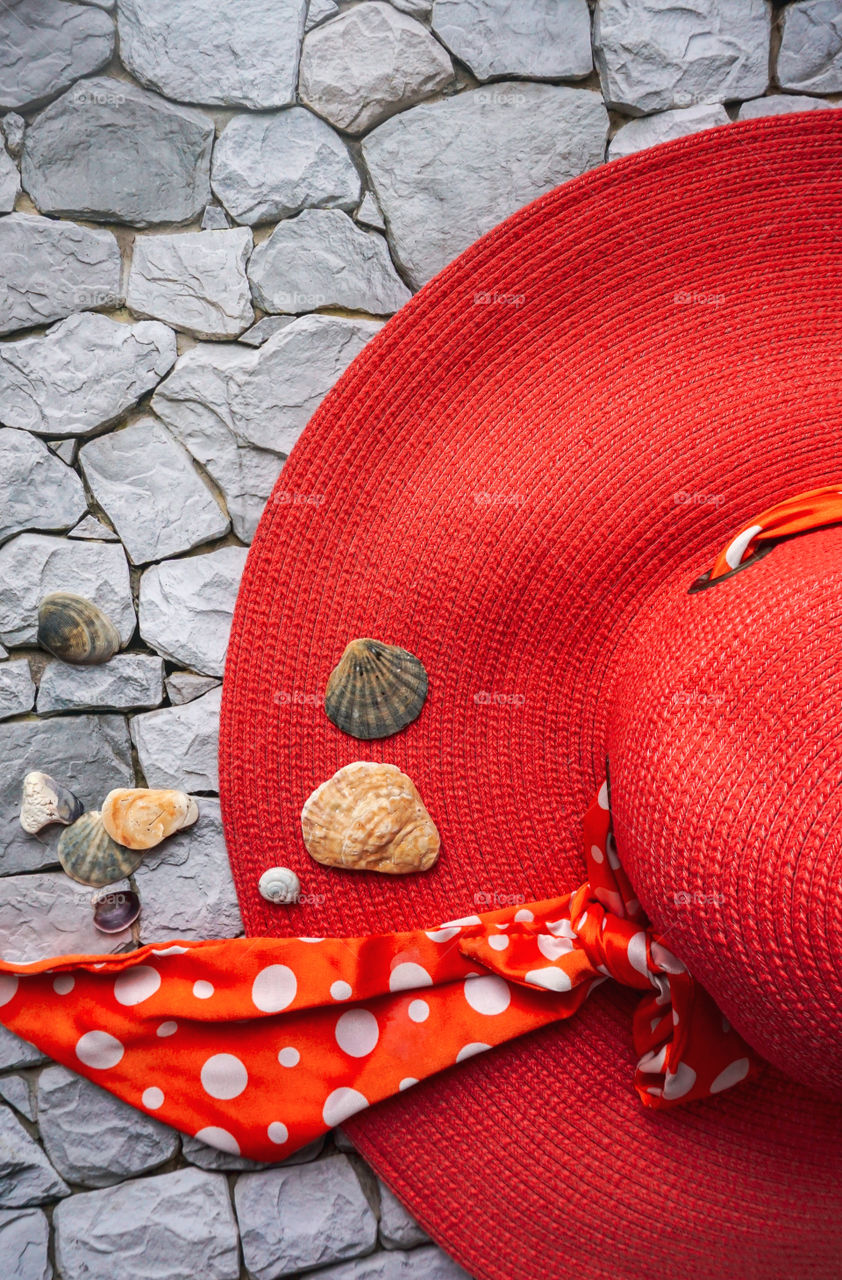 beach hat with goggles on stones