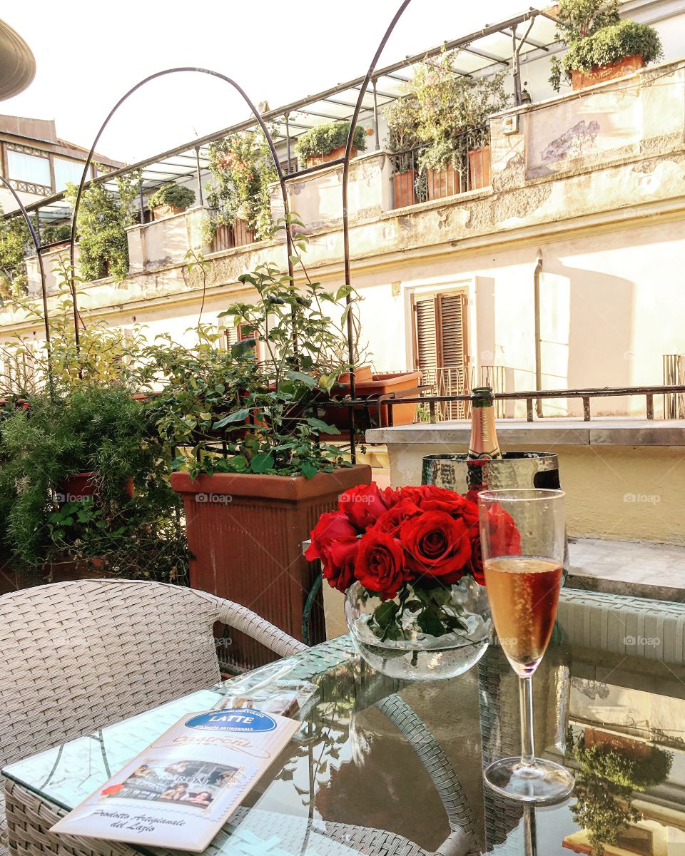 Pink prosecco and roses on the veranda in Rome