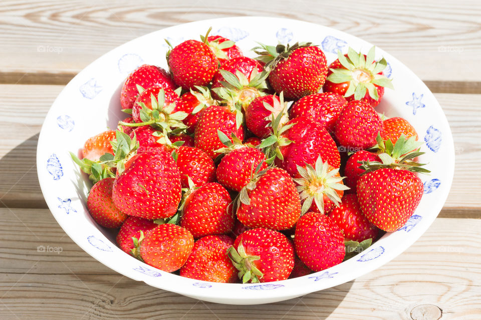 Delicious fresh strawberries in bright sunlight 