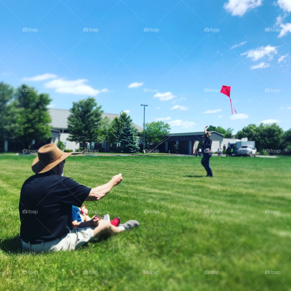 Grandparents and child flying a kite