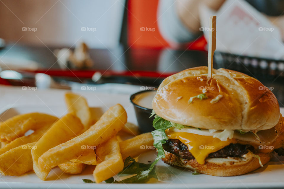 Hamburger and fries served on a table 