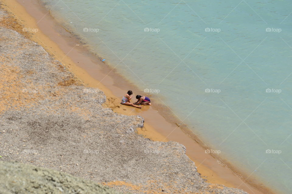 children playing on the beach shore