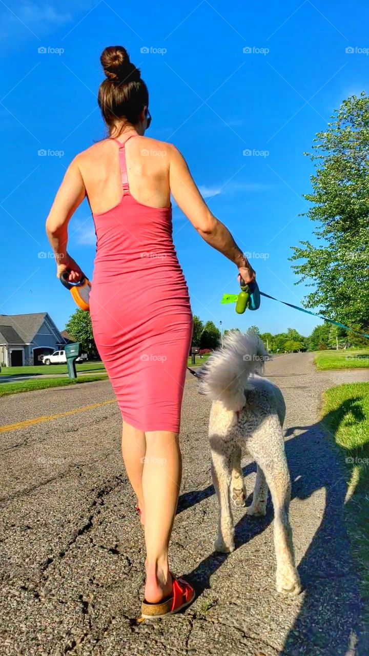 woman in tight dress walking dog