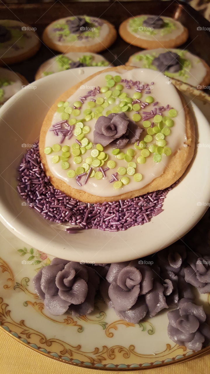 Bake sale sugar cookie with almond frosted glaze and topped with Wilton sprinkles and a handmade lavender molding chocolate rose.