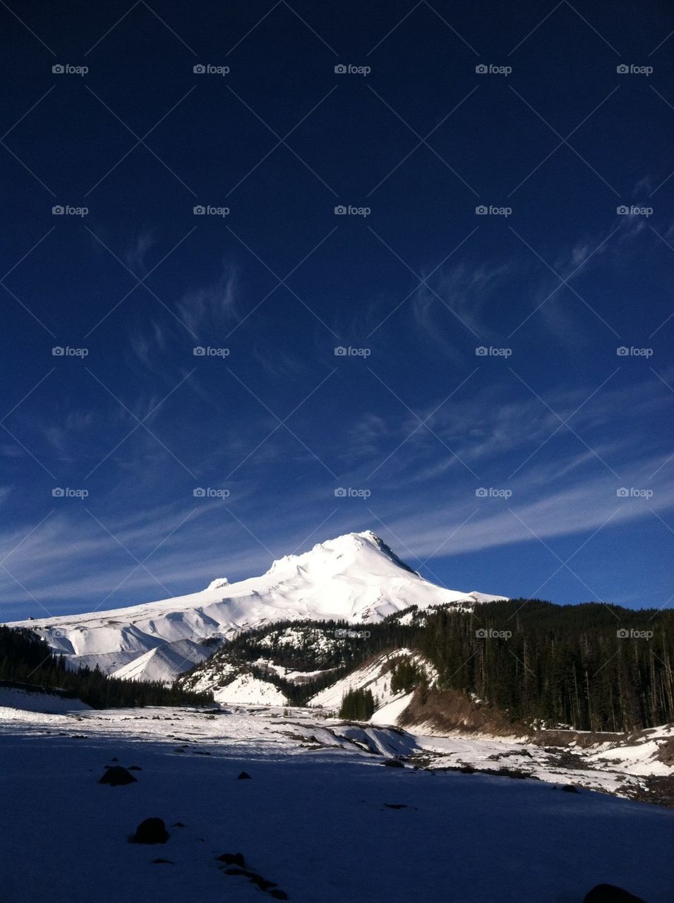 Snowy landscape against blue sky