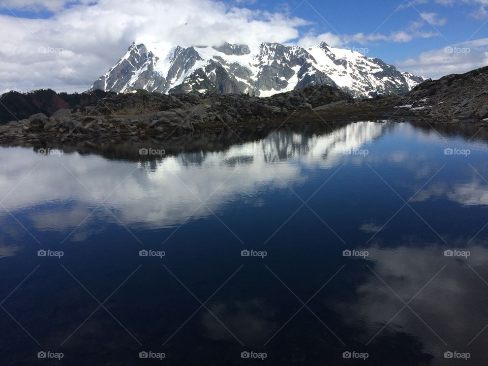 Clouds reflected in a mountain pond. 