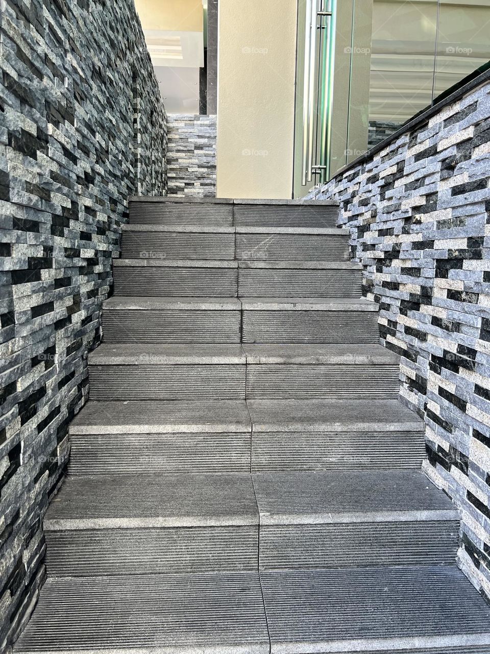 Staircase with bricks wall in both side