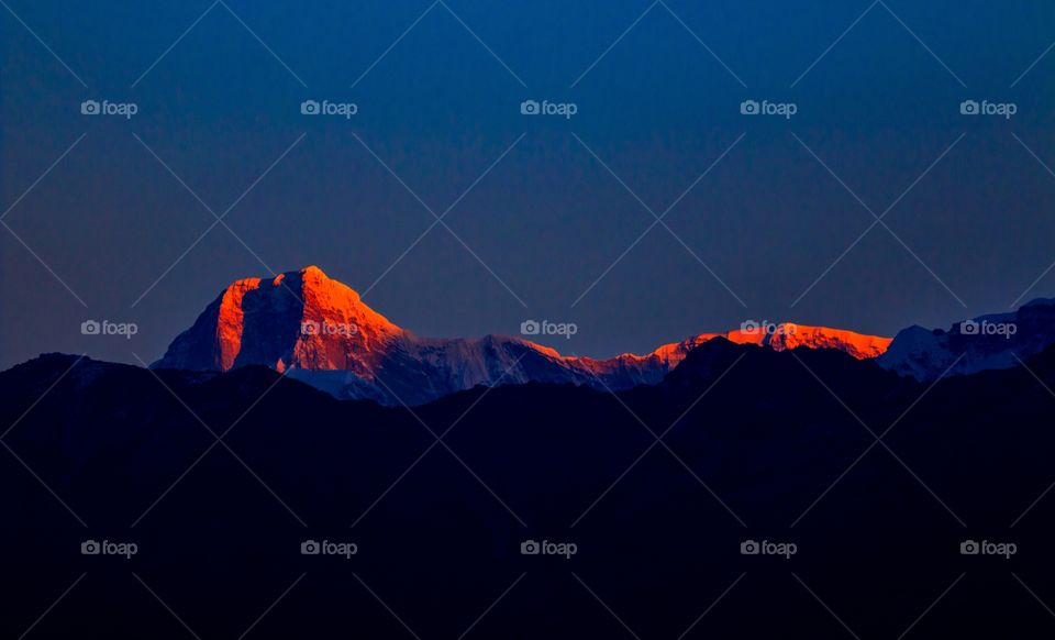 magical morning sunlight falling over snow capped mountains