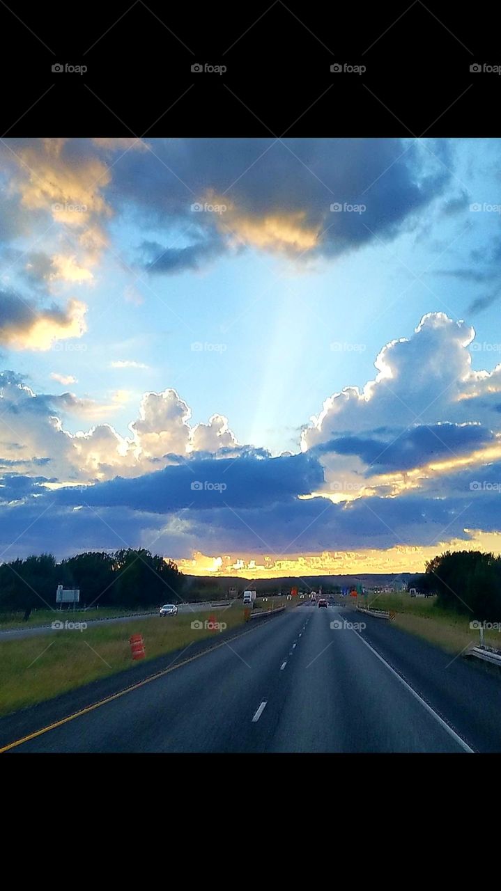 looks like a city of gold at the bottom of the clouds