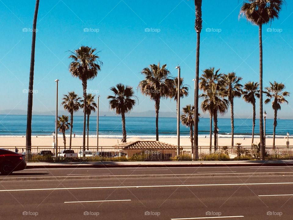 From the gym. Huntington Beach. Invigorating, post-Gym fresh air and balcony stretching. The calm before the storm of beach goers. March. 