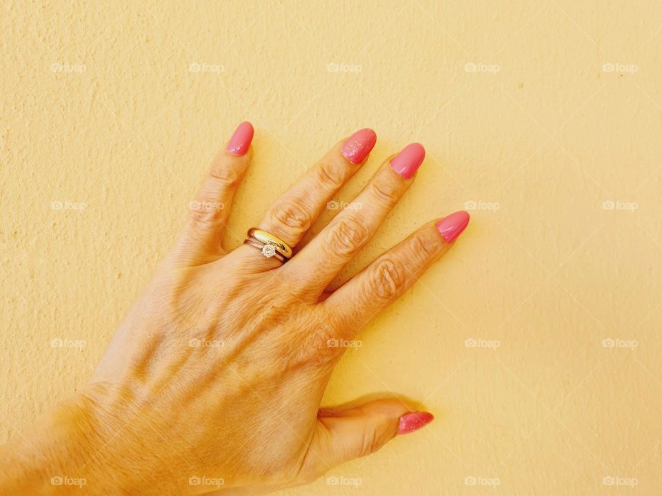 female hand with pink manicure and semi-permanent