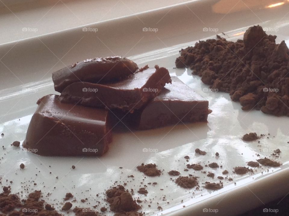 Pieces of fudge with cocoa powder.