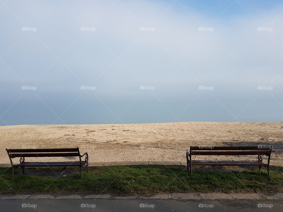 Two benches by the sea/the sea and the sky are like the same thing