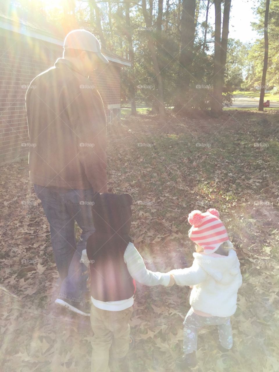 There is no stronger bond between a father and his children. Walking together threw the park while jumping in leaves along the way during fall season. 