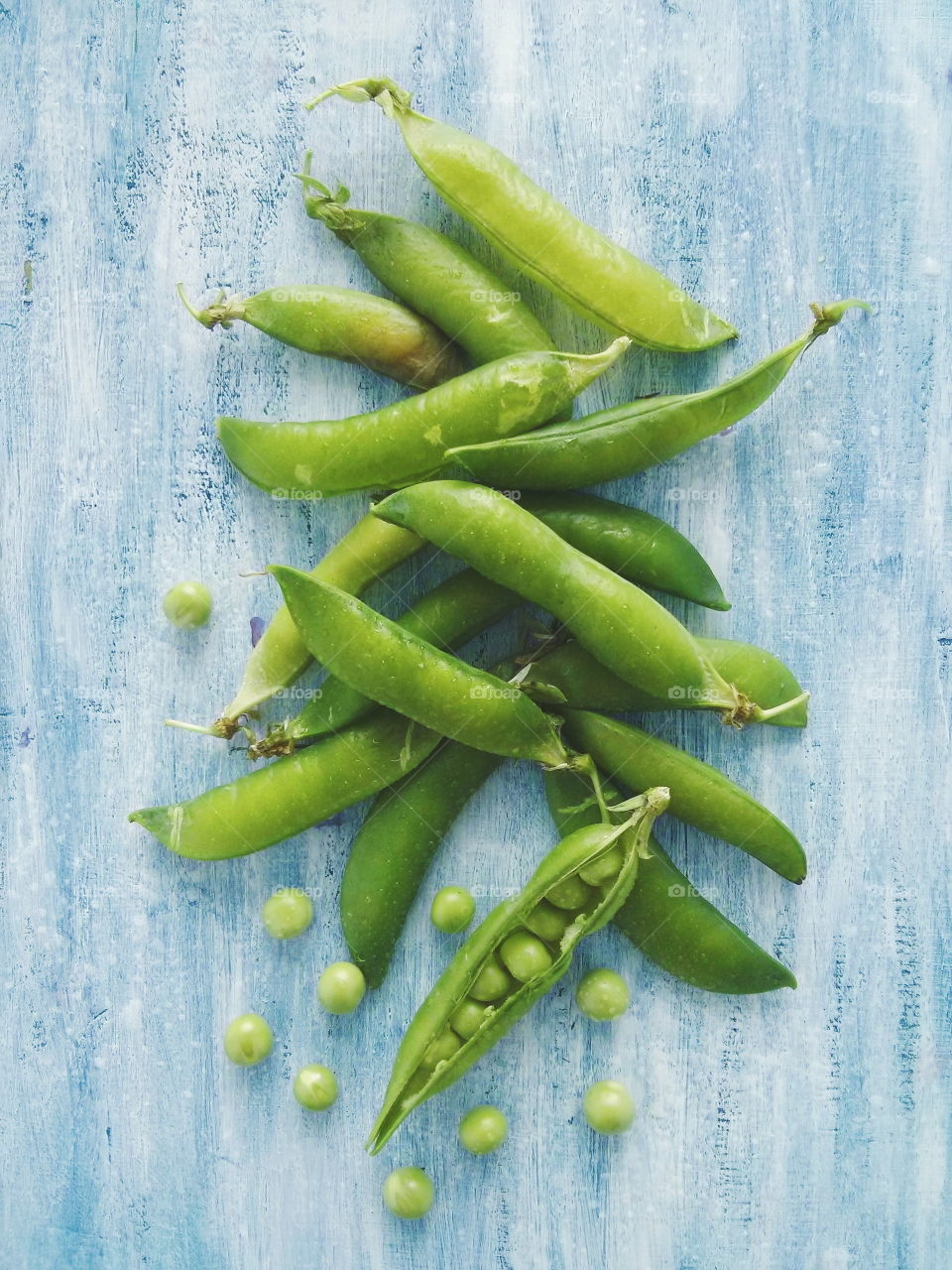 Green peas. Green peas on blue wooden background