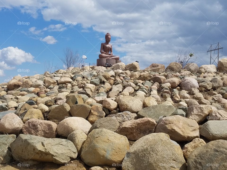 Buddhist statue atop stones