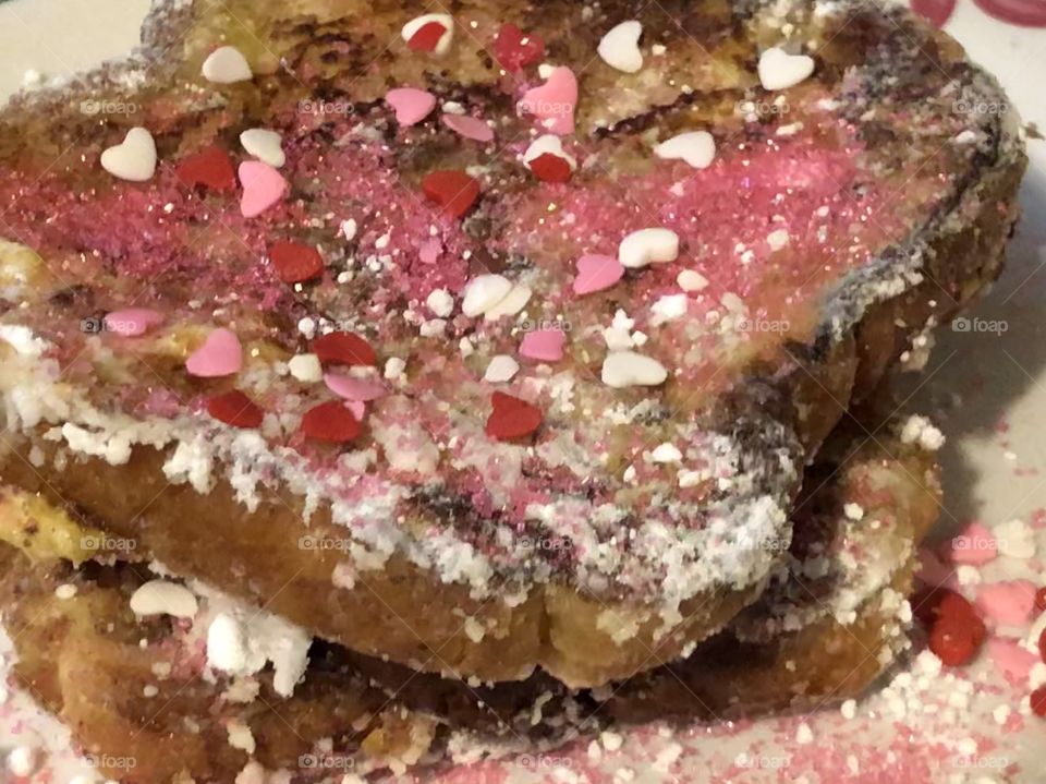 French toast with powdered sugar and heart sprinkles