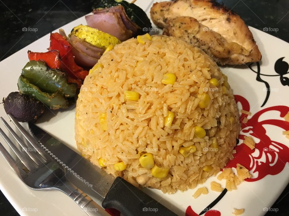 Eating with rice, vegetables and grilled chicken