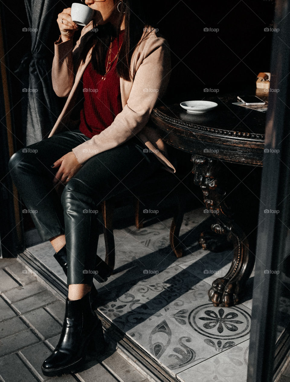 Beautiful brunette girl smile and take cup of coffee in street cafe