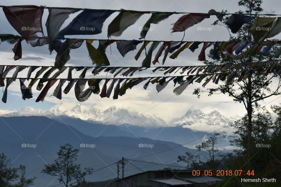 Kanchenjunga, Himalayas distant views, Darjeeling, a beautiful morning and prayer flags.