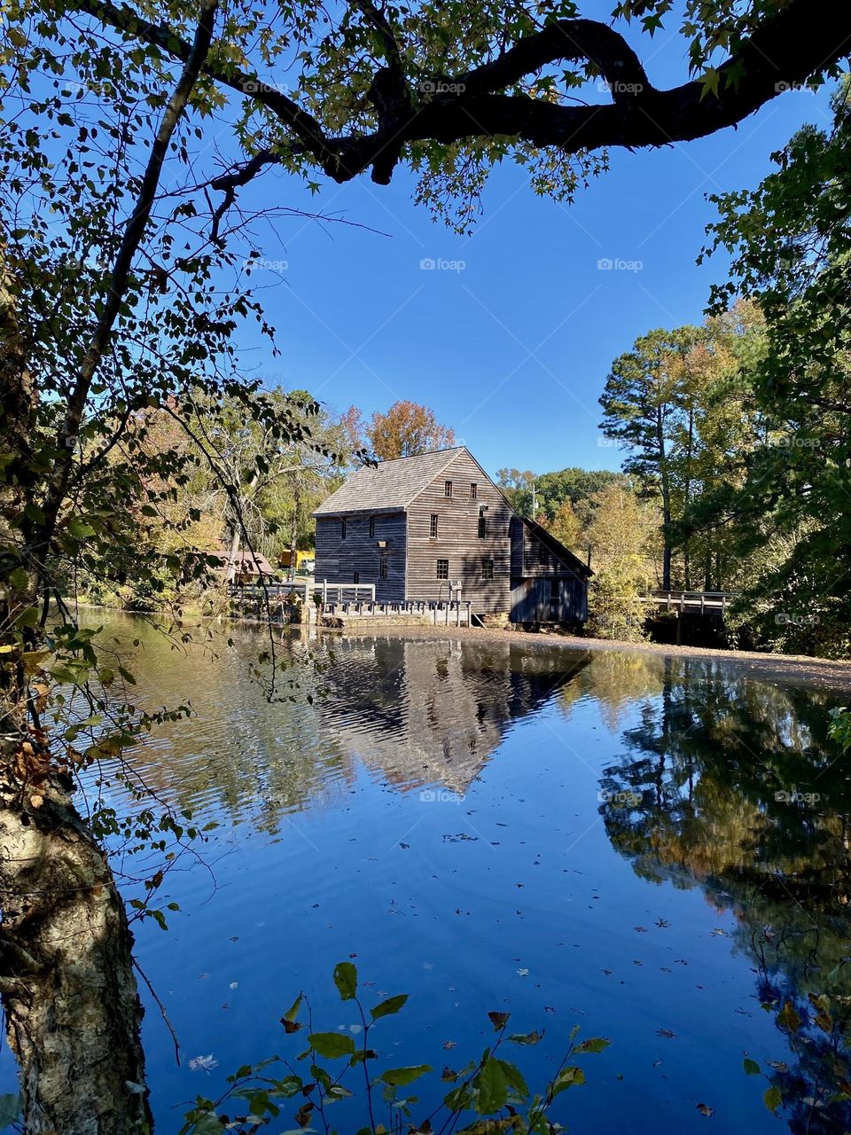 Grist water mill, reflections, blue day