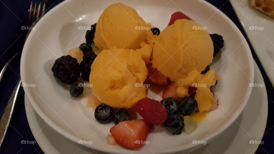 The brilliance of the mango sorbet is highlighted by the magnificent berries.