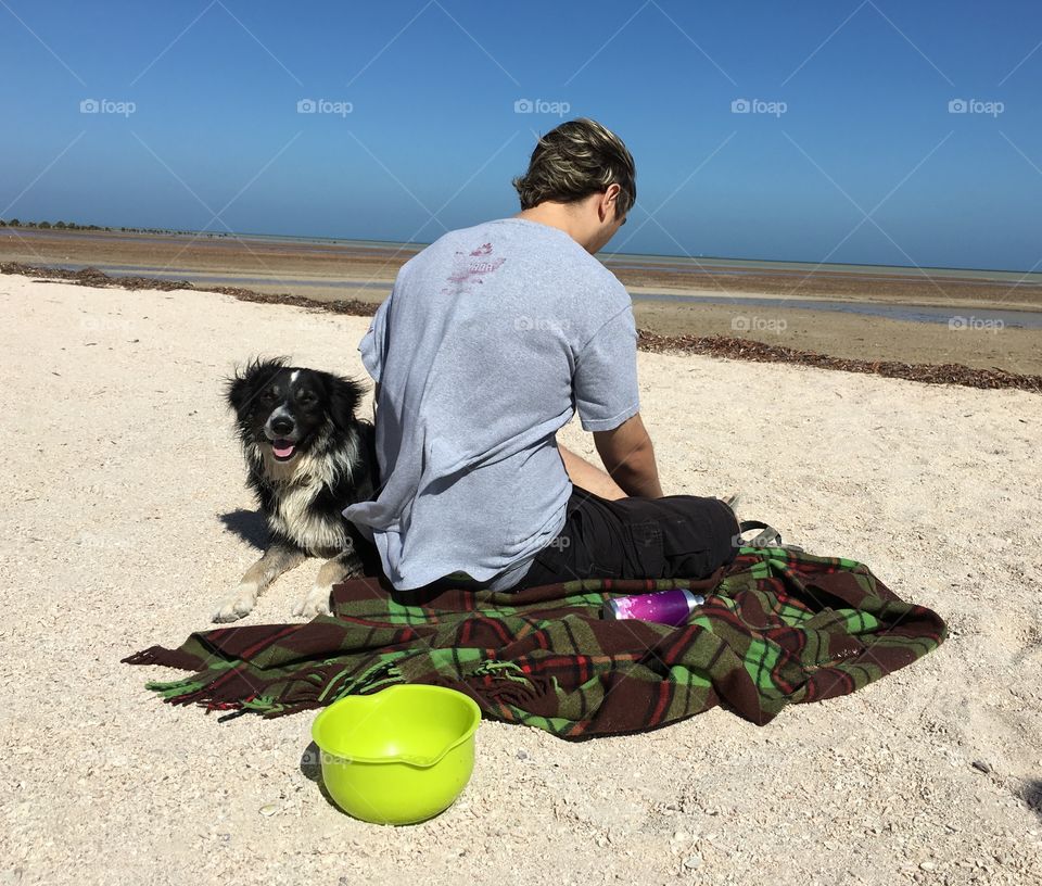 Our border collie peter with my son resting on the beach after a great run at low tide