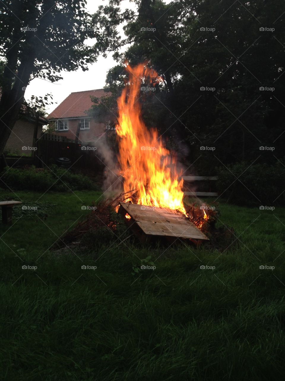 A bonfire rages in summer. 