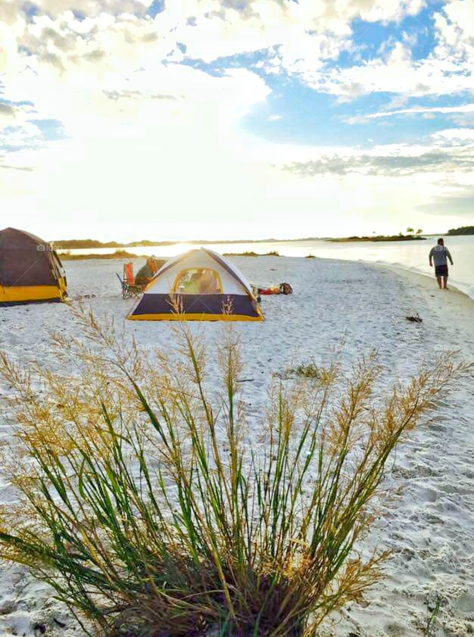 tents on beach by ocean at daybreak