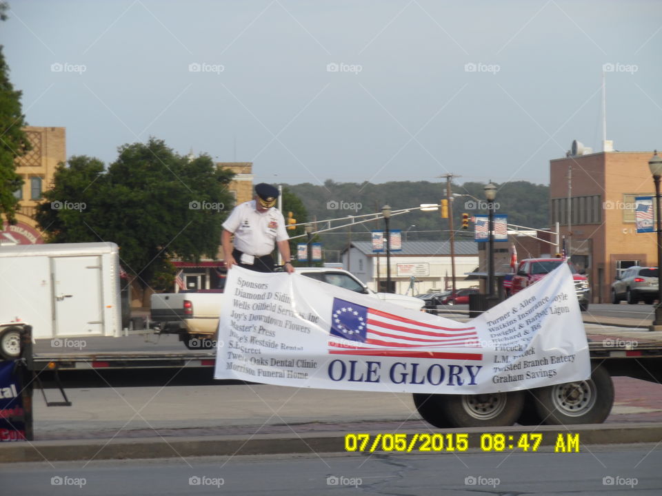 ole glory sign. This honor guard 💂 member was setting up for the fourth of July parade in Graham Texas
