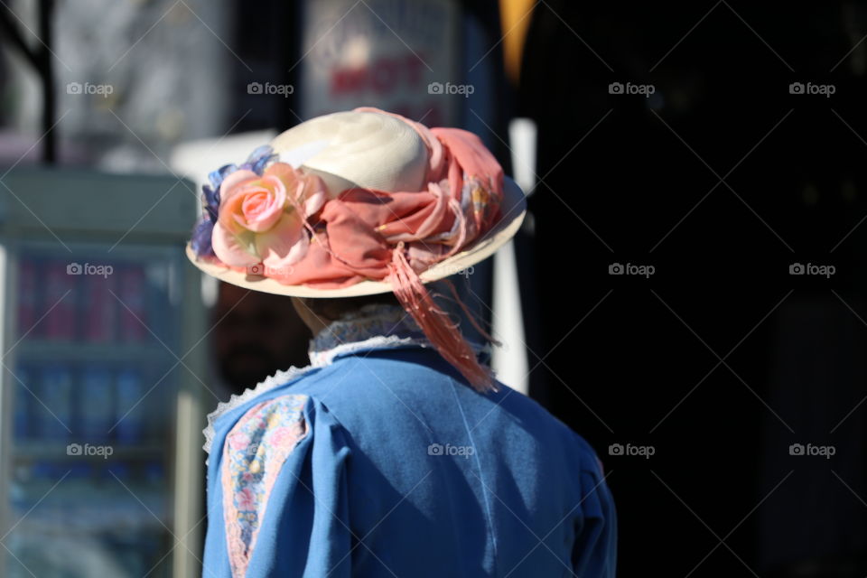 Old
Fashioned woman wearing floral bonnet with ribbons outdoors 