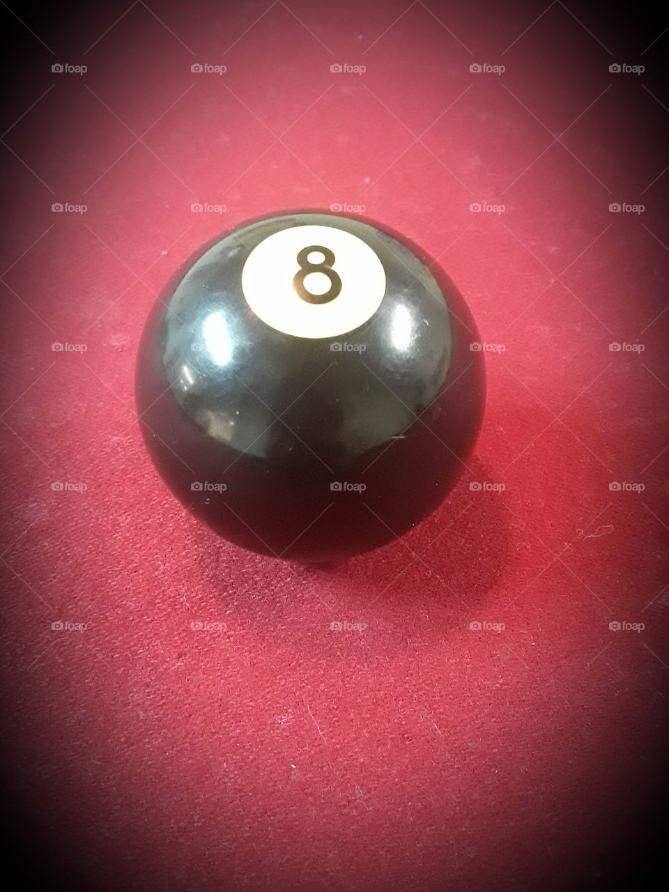 8 ball billiard ball on pool table