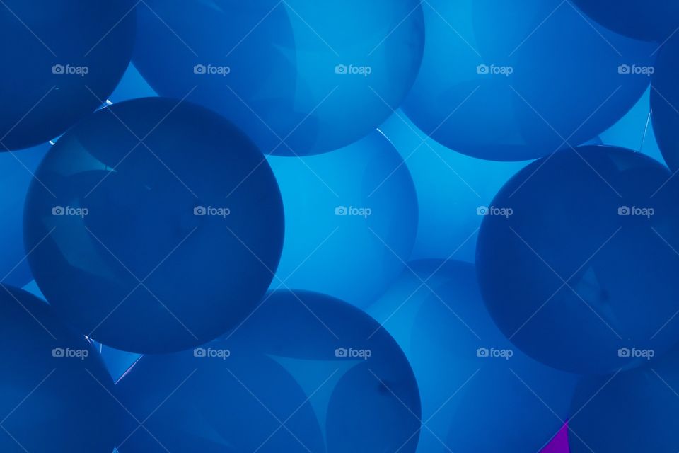 Shades of blue inflated balloons captured at a parade in New York City.