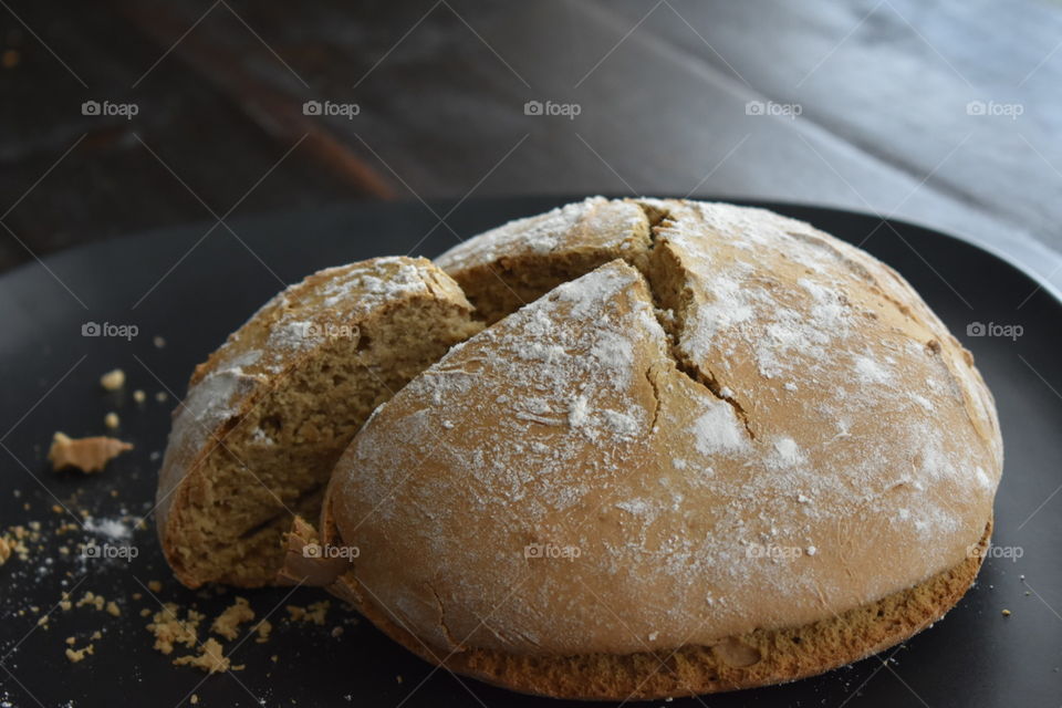 A baked loaf of traditional Irish soda bread sprinkled with flour