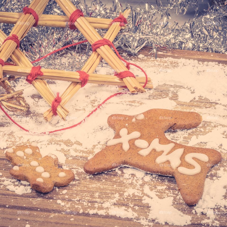 Christmas cookies on a wooden table with flour
