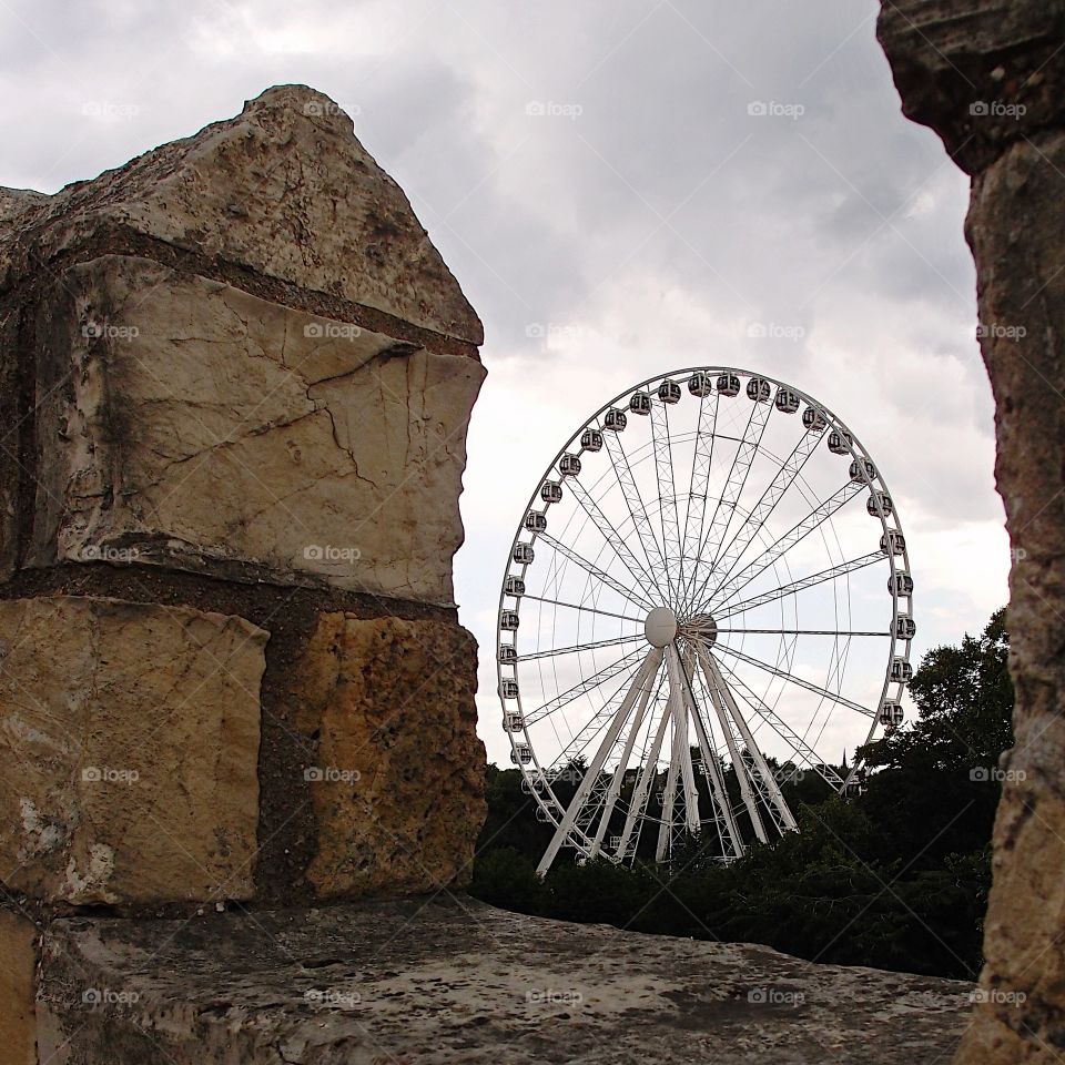 The York Wheel viewed through the historic York Wall in England on a summer day. 
