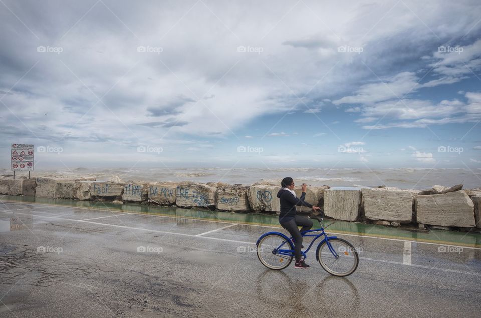 Stormy day with a cyclist taking a picture with the phone