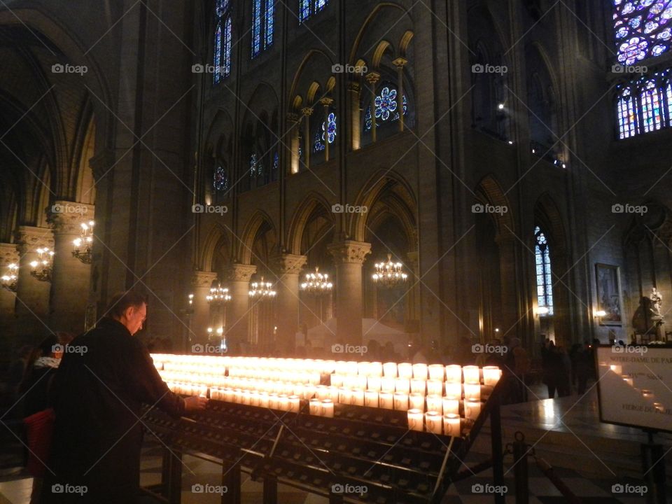 A man worshipping in The Cathedral of Notre Dame, in Paris, France. May 2012. Copyright © CM Photography 2012. @chelseamerkleyphotos on Foap.